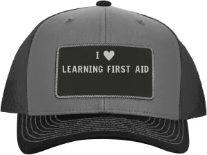 I Heart Love Learning First Aid - Leather Black Patch Engraved Trucker Hat